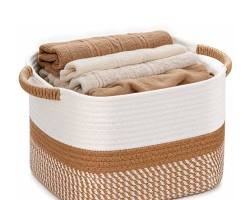 Cotton woven storage basket filled with folded neutral towels