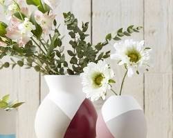 Sculptural ceramic vases styled with white flowers and greenery